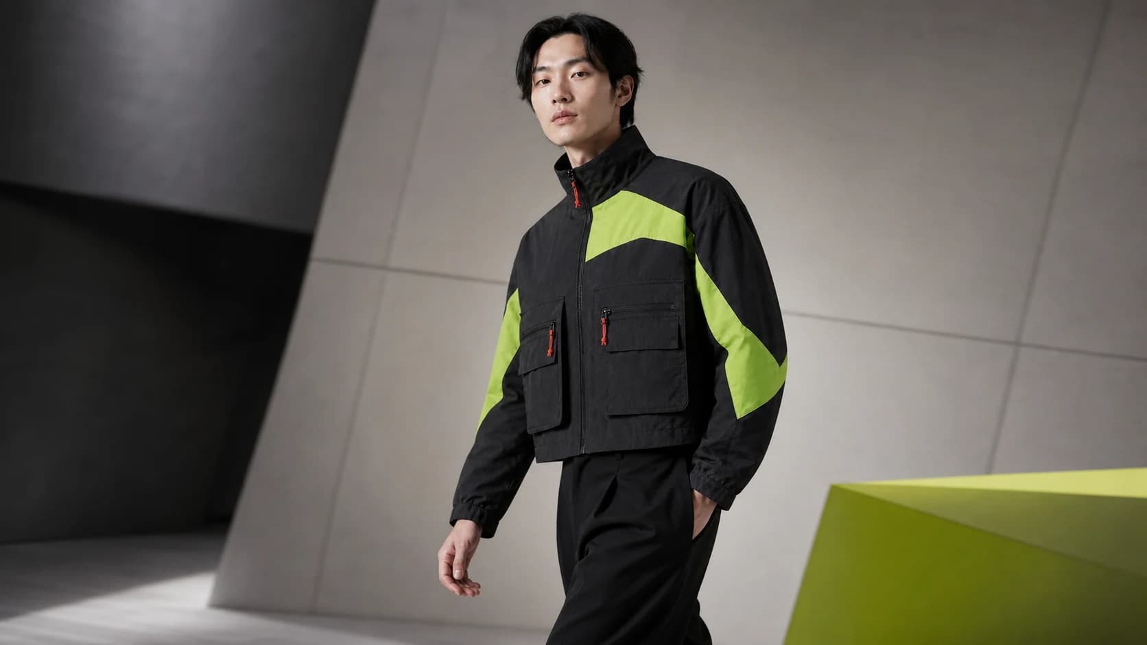 Same charcoal utility jacket shown in a campaign frame